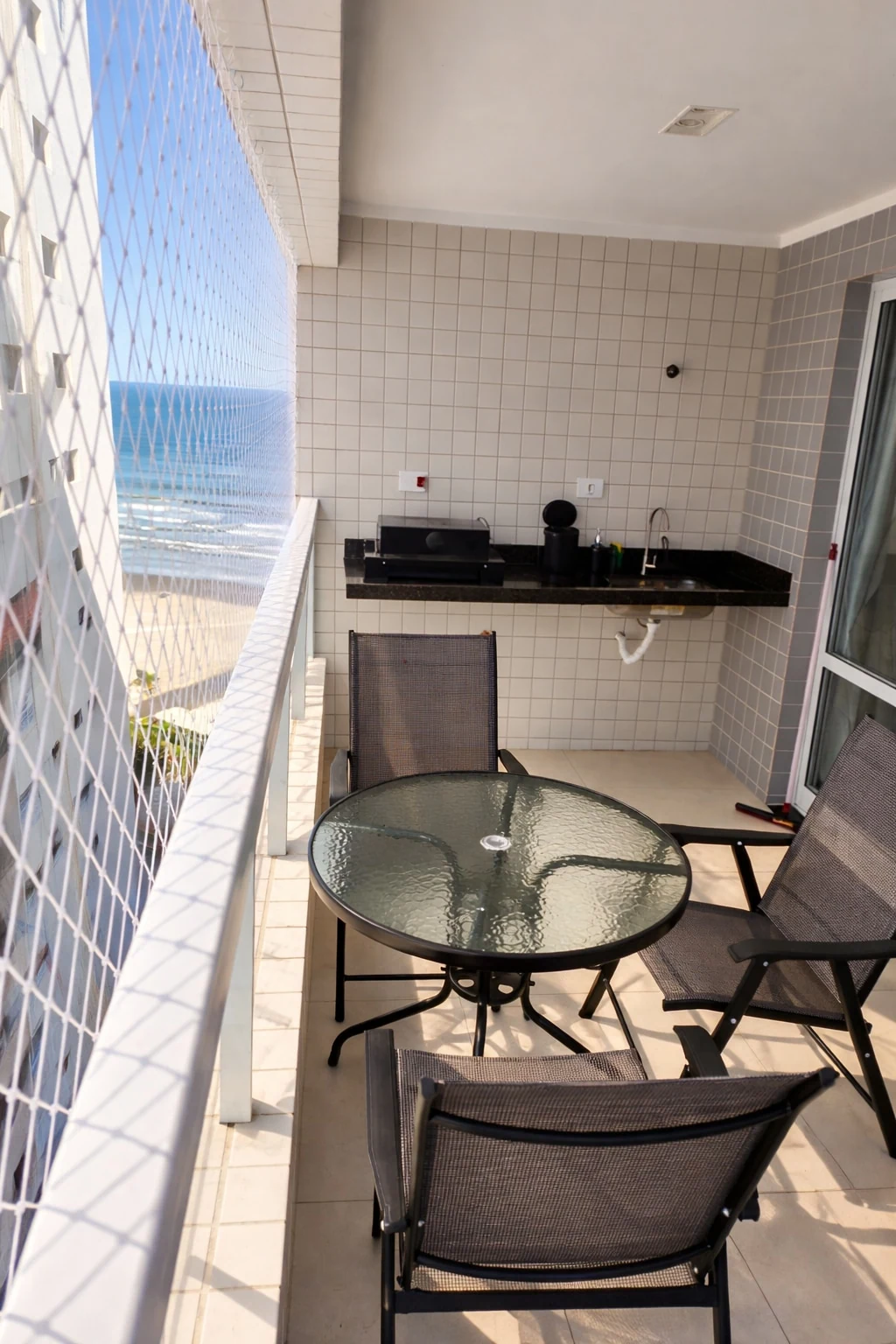 Varanda e pia, apartamento pé na areia em Praia Grande