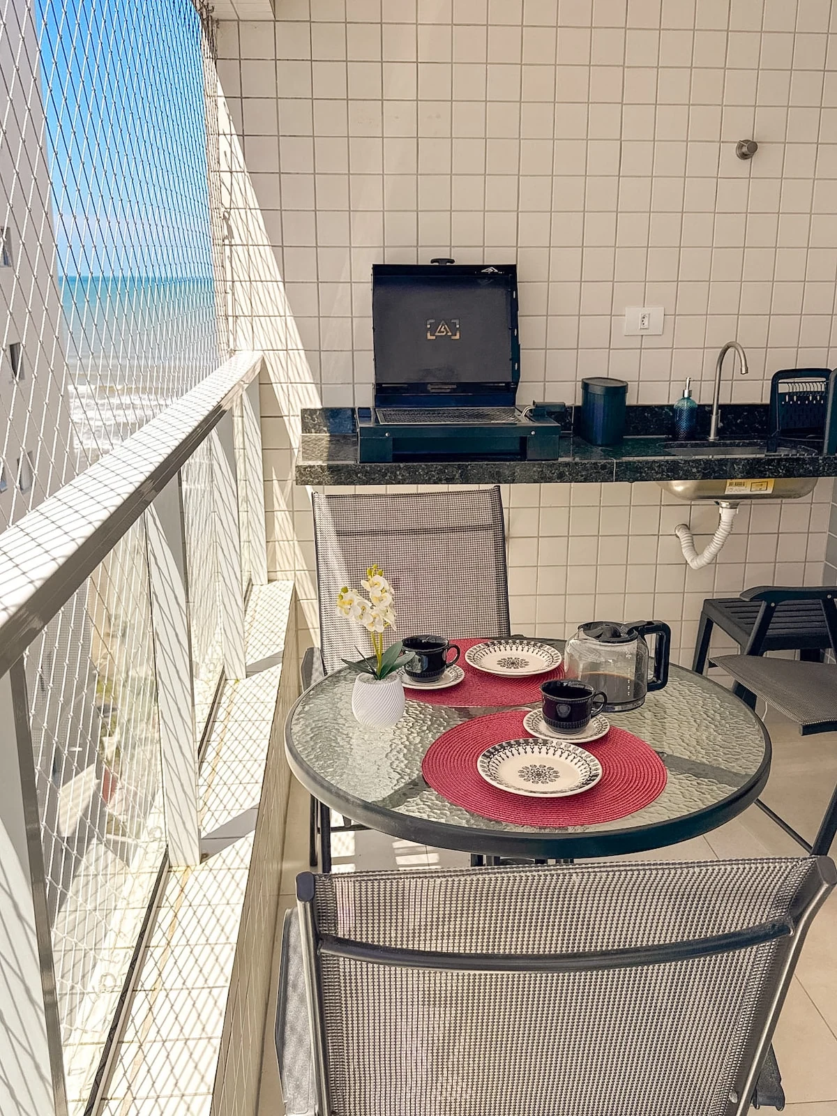 Varanda com churrasqueira, apartamento pé na areia em Praia Grande